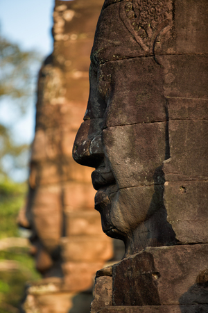 Stone heads on towers of Bayon temple in Angkor Thom, Cambodiaの写真素材