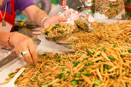 Selling Bamboo worm fried food in the marketの写真素材