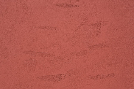 old red cement wall surface as textured backgroundの写真素材