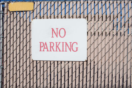 no parking sign on modern vertical plastic and wire wall