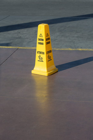 Slippery floor surface warning sign and symbol in building, hall, office, hotel , restaurant,...
