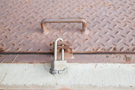 aged diamond metal texture pattern used as abstract background, grunge diamond metal plate with lock