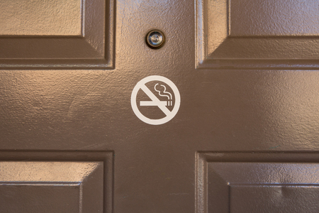 No smoking sign on the brown doorの写真素材