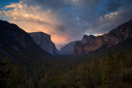 Classic Tunnel View of scenic Yosemite Valley with famous El Capitan and Half Dome rock climbing summits in beautiful golden  light at sunset in summer, Yosemite National Park, California, USAの写真素材