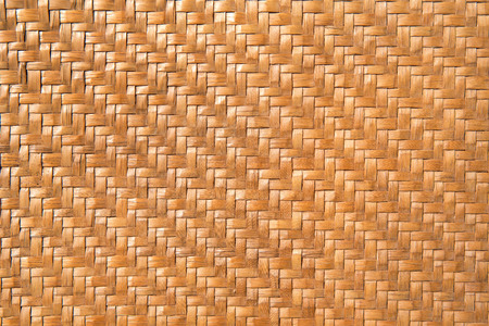 traditional thai style rattan pattern light orange color made from bamboo handcraft weave texture wicker surface for furniture materialの写真素材