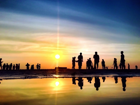 The Silhouettes are Activities on the Beach at Sunsetの写真素材