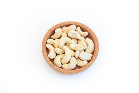 Roasted cashew in bowl isolated on white background.の写真素材