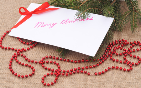 Christmas card with bow on a brown background.の写真素材