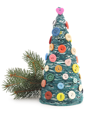 Christmas tree with yarn and buttons isolated on a white background.の写真素材