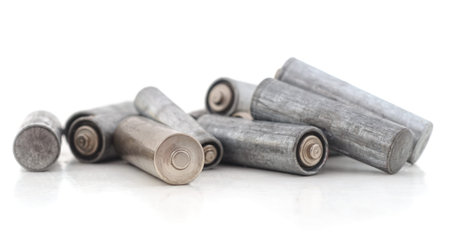 Heap of old batteries isolated on white background.