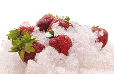 Strawberries and ice are isolated on a white background.の写真素材