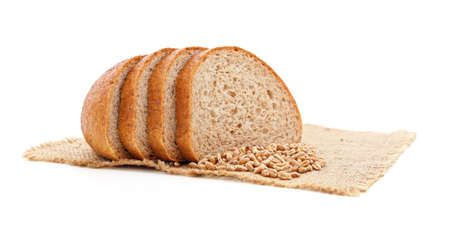 Wheat and bread on sacking isolated on a white background.の写真素材