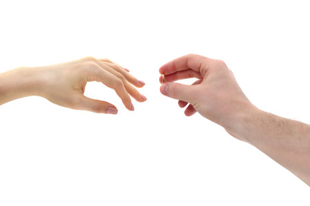 Man's hand puts a wedding ring on a woman's finger isolated on a white background.
