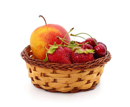 Apple with strawberries and cherries in a basket isolated on a white background.の写真素材