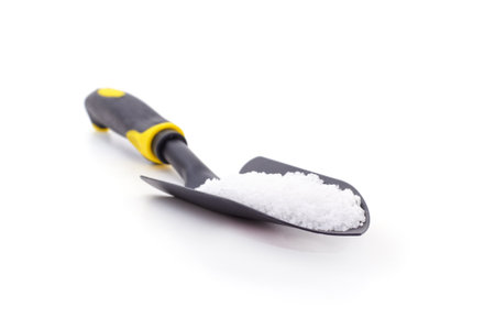 Mineral fertilizer in a shovel isolated on a white background.の写真素材