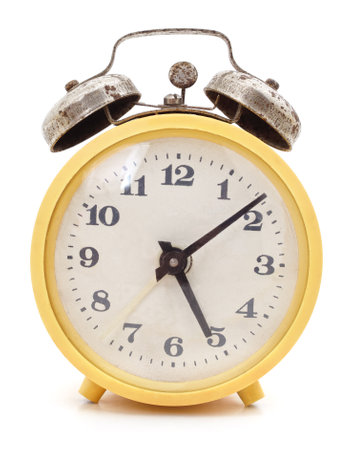 Old yellow alarm clock isolated on white background.の写真素材