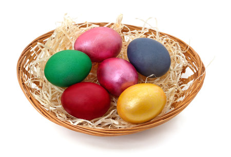 Easter eggs in a basket isolated on a white background.の写真素材