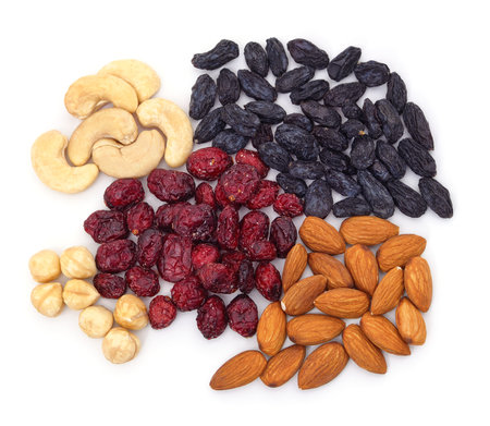 Handfuls of nuts and dried fruits isolated on a white background.の写真素材