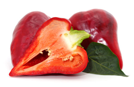 Red pepper cut into halves isolated on a white background.の写真素材