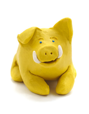 Yellow plastic pig isolated on white background.の写真素材