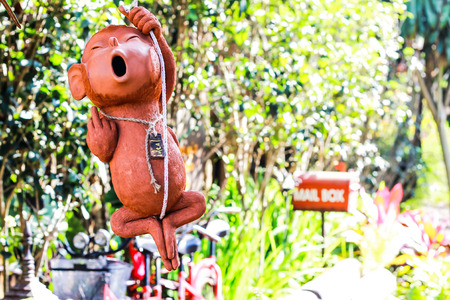 The clay statue is a monkey hanging rope to decorate the garden or restaurant is very popular.の写真素材