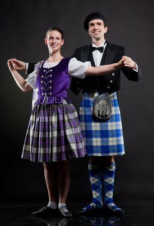 The pair dancing the Scottish dance in a kiltの写真素材
