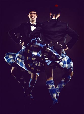 Two young man dancing the Scottish dance in a kiltの写真素材