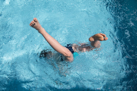 Swimming in the hotel pool. A young man dives into the pool at the hotel.