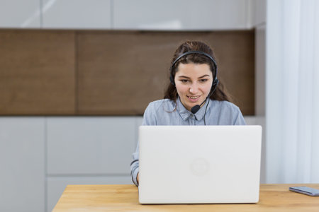 Woman talking on a headset through a laptop