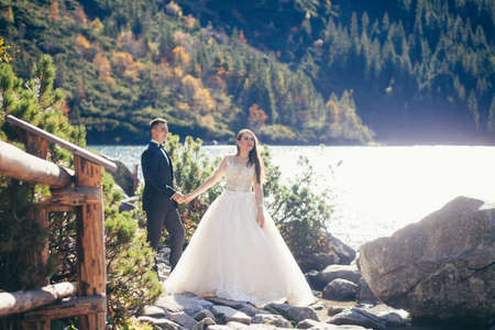 Wedding photo shoot, a young couple in love in the mountains near a large beautiful lakeの写真素材