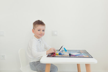 The man's father, playing a board game with her young son spend time togetherの写真素材