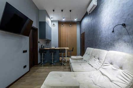 interior photography, large kitchen studio together with living room in loft style, in dark colorsの写真素材