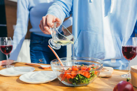 Close-up photo, hands cut vegetables into saladの写真素材