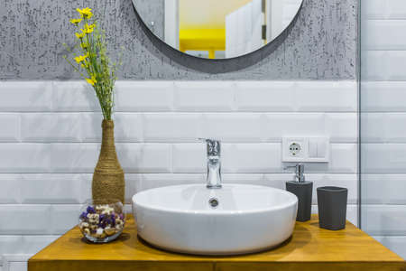 Bathroom with white tiles in a modern small apartmentの写真素材