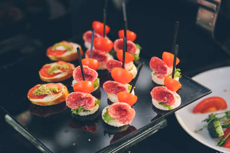 photo of snacks on a buffet banquet table cold snack dishesの写真素材