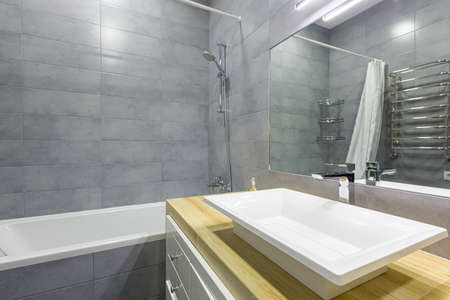 interior photo of a modern bathroom with gray tiles in a small apartmentの写真素材
