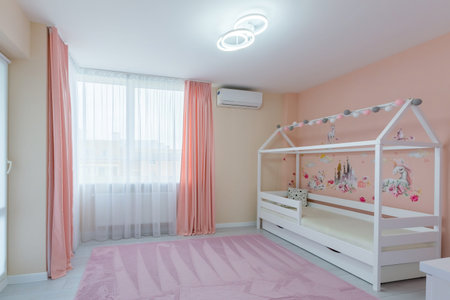 Interior photo children's room for a girl of light color with pink, with a white cot