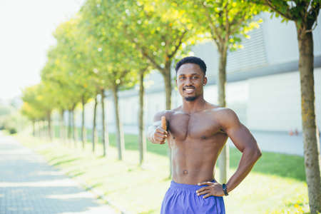 Portrait of a male athlete looking into the camera motivates the coach to lead an active lifestyleの写真素材