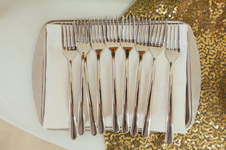 Unfolded dessert forks on a festive table top view