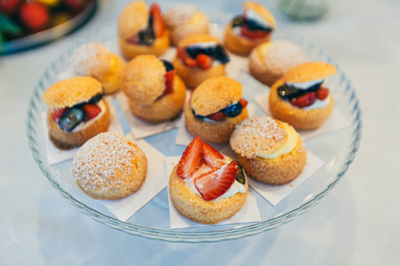 Festive buffet table with delicious desserts of different colors at the wedding ceremony