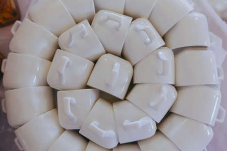 Background texture with white coffee cups laid out in a circle on the tableの写真素材