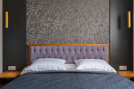 Interior of a modern hotel room with a large double bedの写真素材