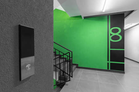 Elevator call button in the hallway entrance to an apartment buildingの写真素材