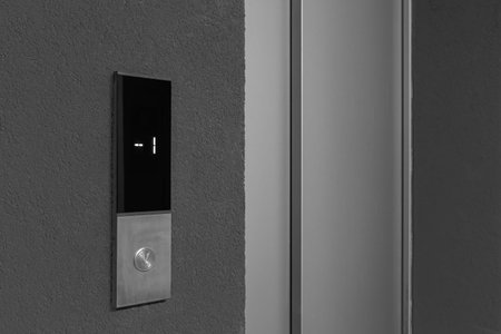 Elevator call button in the hallway entrance to an apartment building