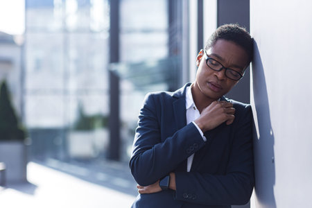 Close-up photo of an office worker, tired and overworked, has a severe headache and depression, an...