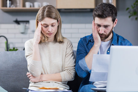 Man and woman, young family together intentionally reading a letter, frustrated