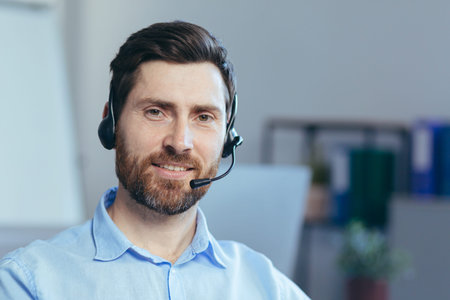 Close-up portrait of a businessman with a headset for a video call, a man looking at the camera...