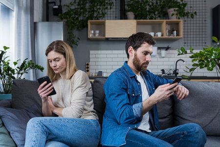 conflict, quarrel. Man and woman, couple, family sitting on the couch with their backs to each other...