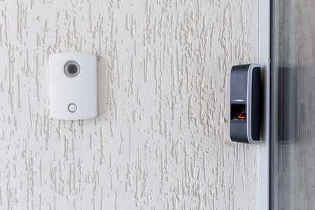 Door lock on door with fingerprint sensor, entrance to modern office and home.