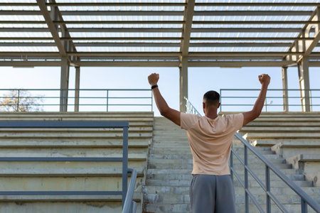 Latin american male athlete happy with training results celebrating successful sport achievement,...
